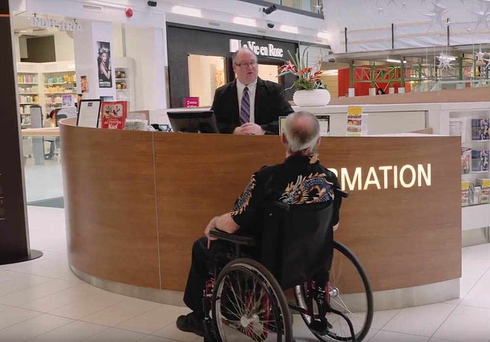 disabled person asking for information at alexis nihon