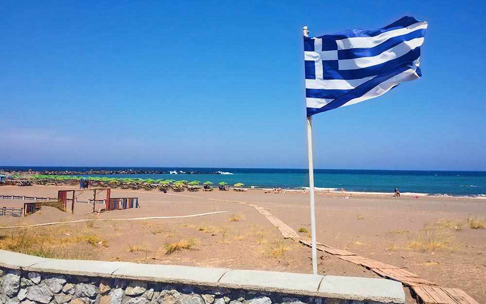 Greece's flag on beach