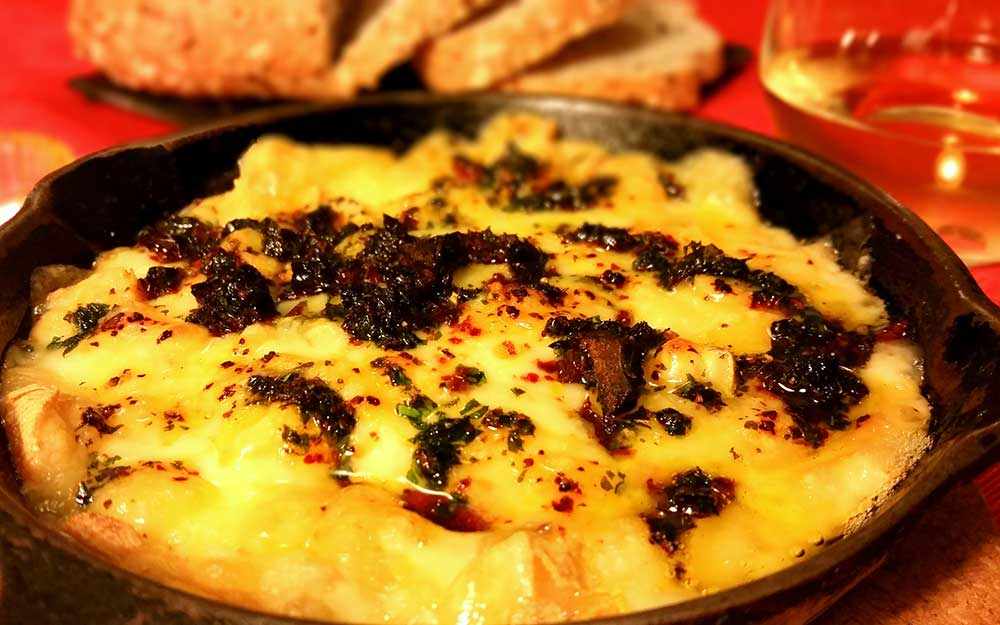 Melted fontina cheese with sundried tomatoes, garlic and herbs
