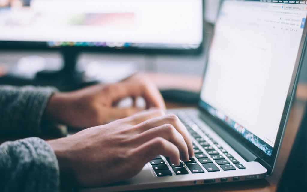 Typing at computer - WestmountMag.ca