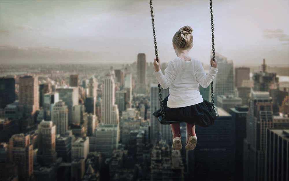 girl on swing above Manhatten - WestmountMag.ca