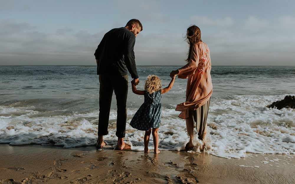 parenting couple with child at seashore - Westmountmag.ca