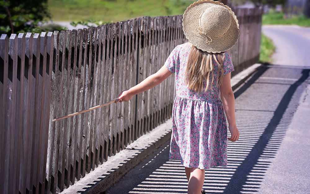 young girl by fence - WestmountMag.ca