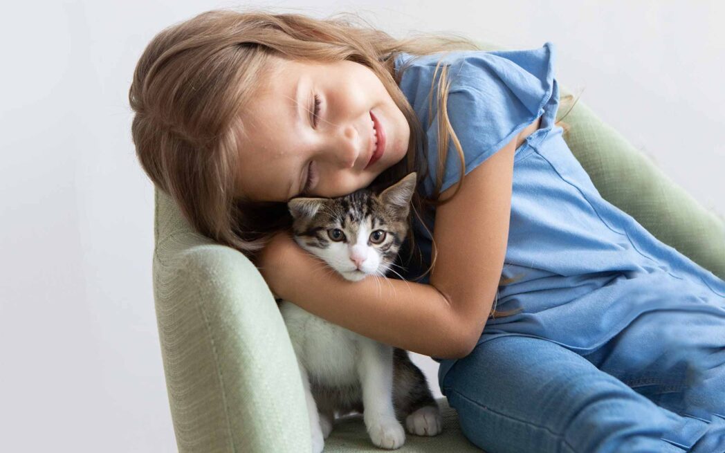 child hugging cat