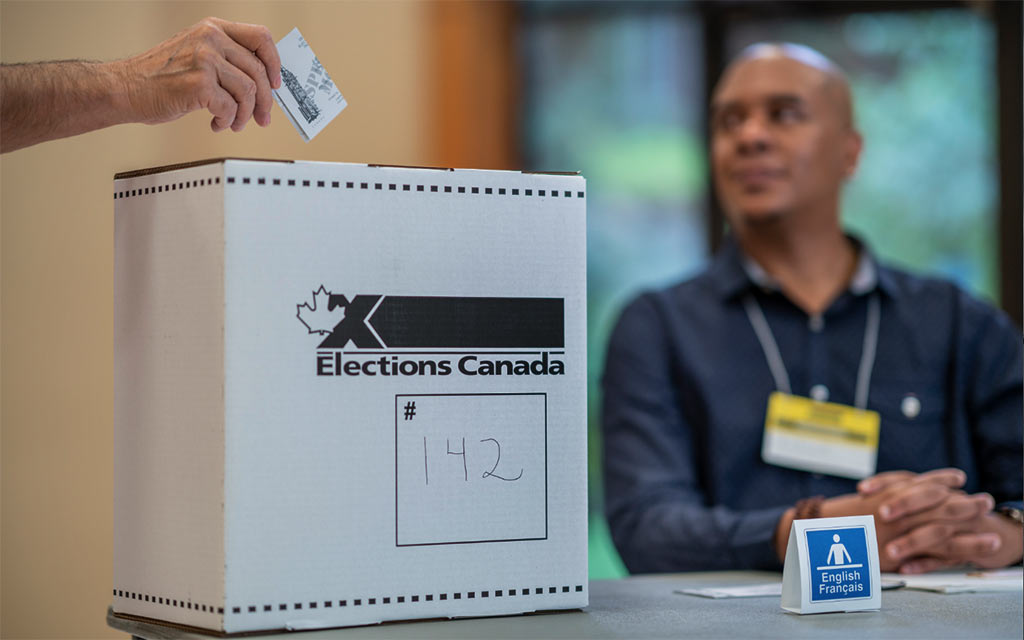 Election Canada - Voter depositing ballot
