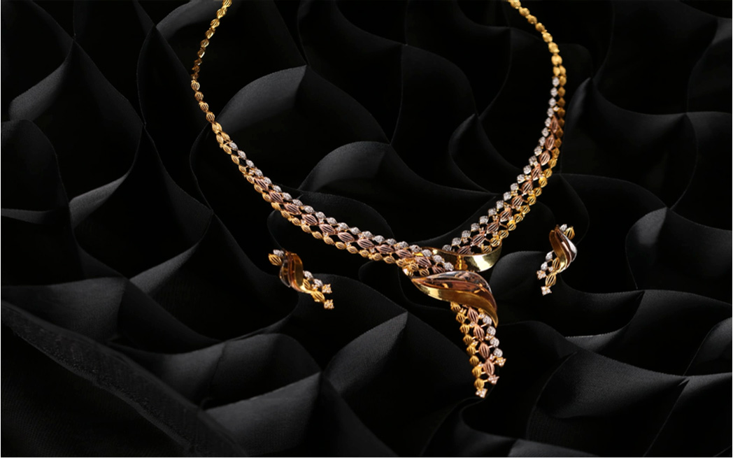 Gold jewellery against a black background