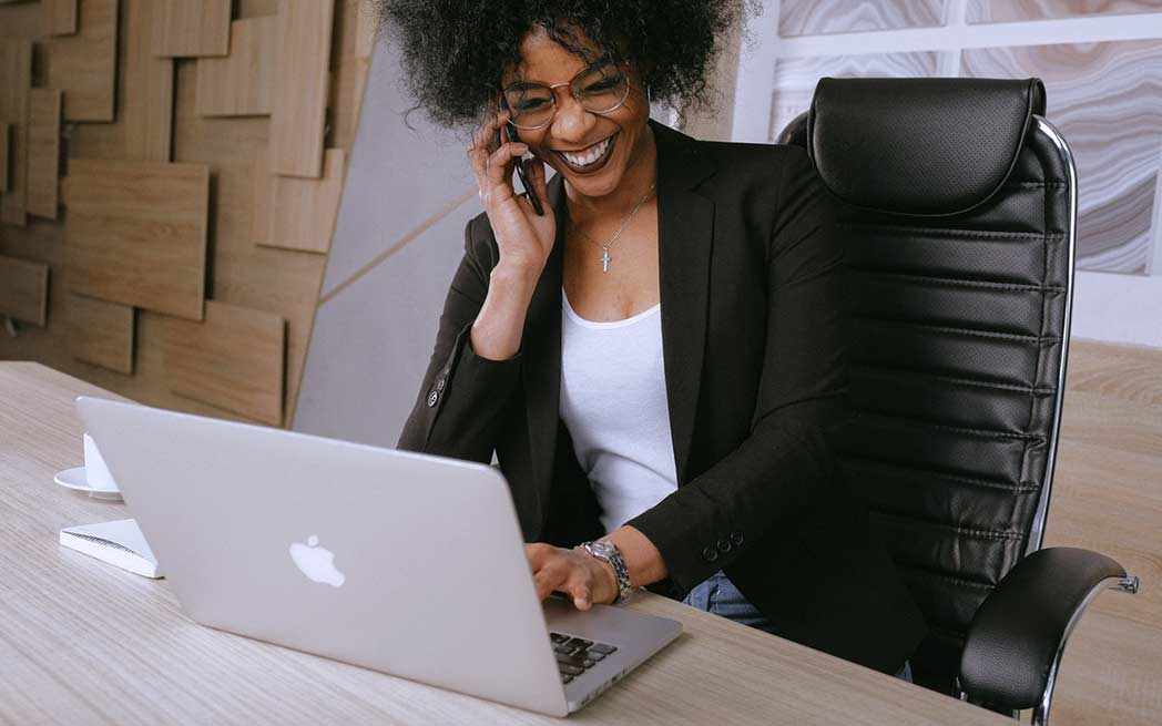 woman on phone at desk - WestmountMag.ca