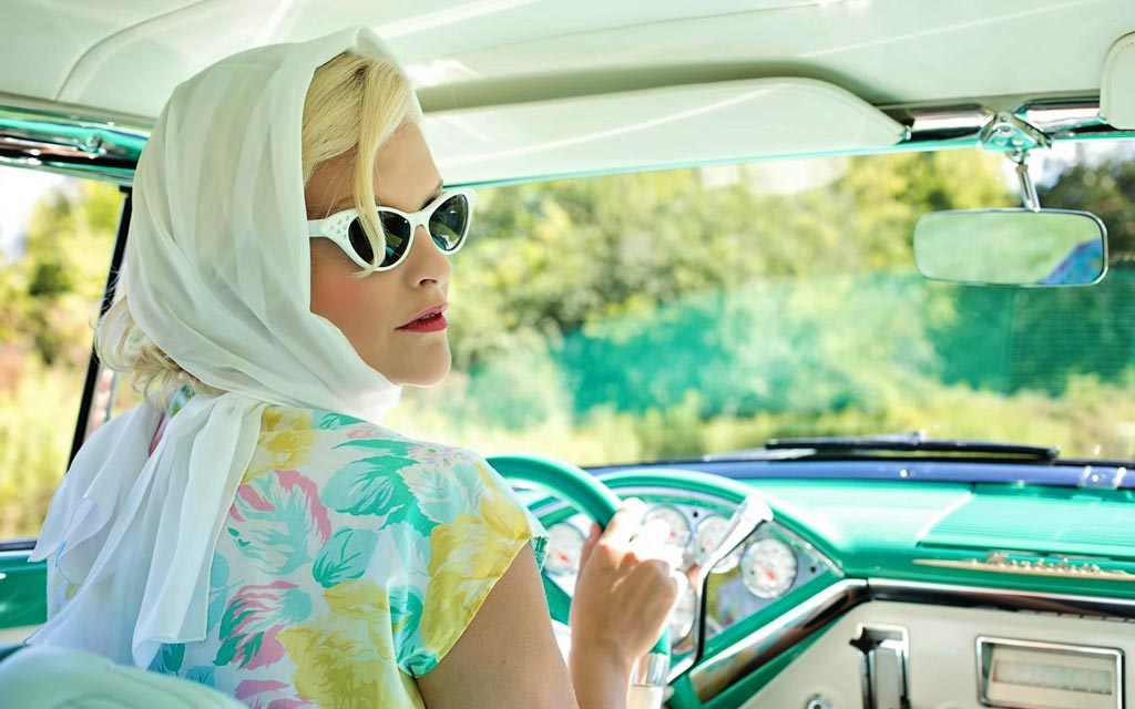 lady driving vintage car