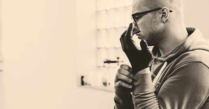 man putting on gloves - WestmountMag.ca