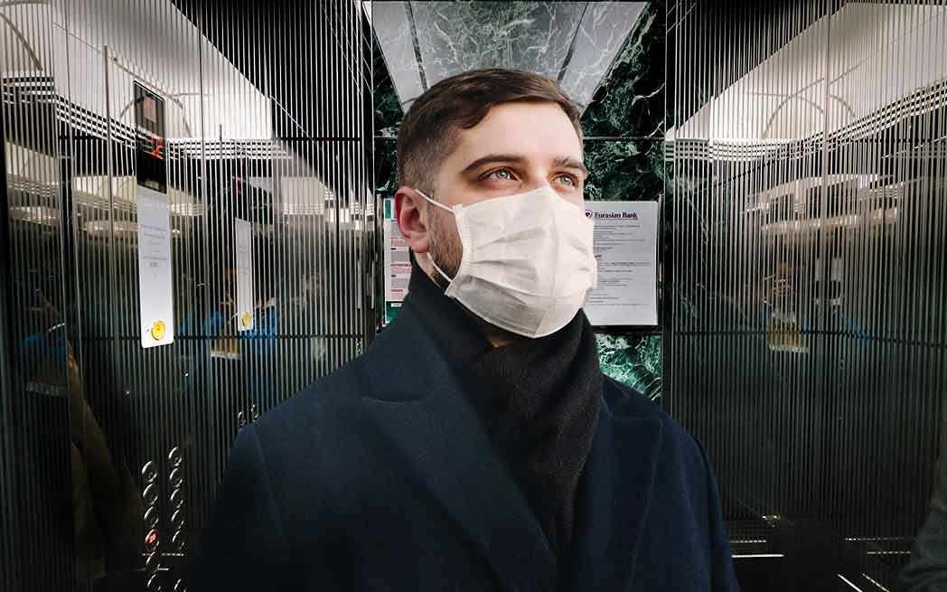 man wearing mask in elevator - Westmountmag.ca