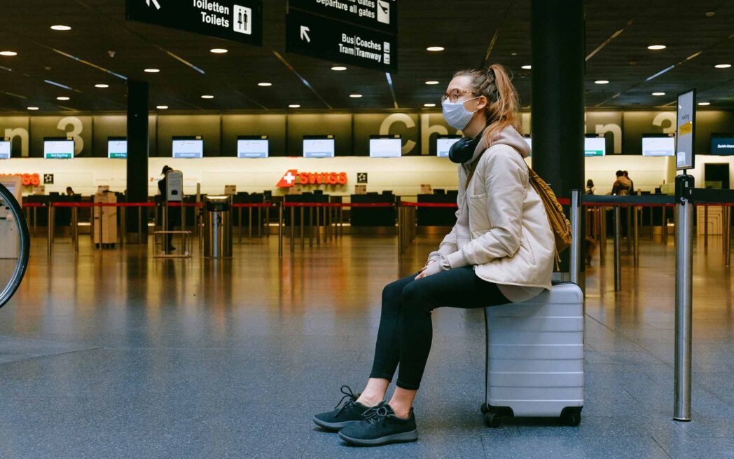 Masqued passenger waiting in airport