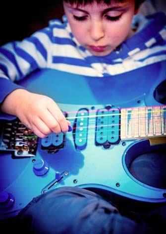boy playing guitar - WestmountMag.ca