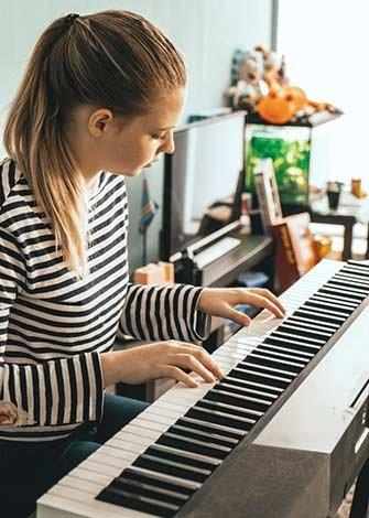 girl playing piano - WestmountMag.ca