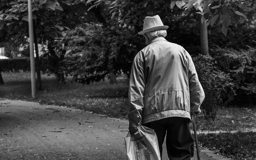 old man walking with cane