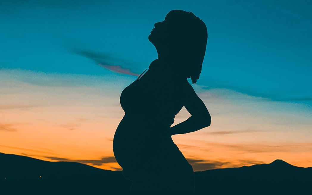 pregnant woman at sunset